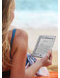 Kindle Touch e-reader: reads like real paper, even in bright sunlight, as shown by woman reading a Kindle by the pool