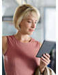 Kindle Touch e-reader: woman holding Kindle Touch while on commuter train