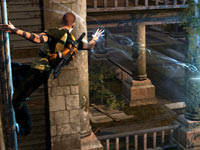 Cole zapping a human enemy while hanging from the side of a building in inFAMOUS 2