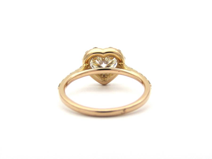 18K gold heart-shaped diamond halo ring.