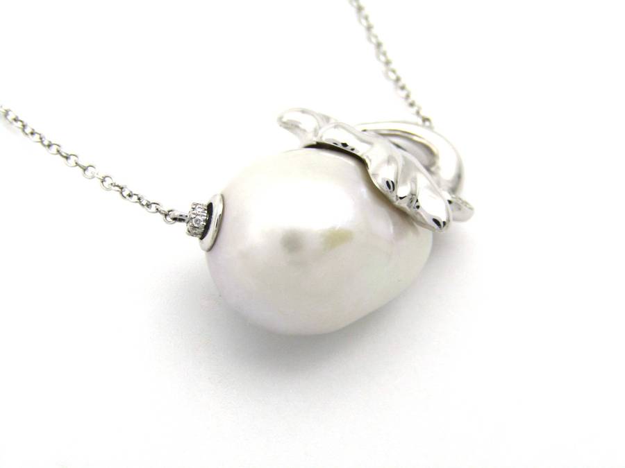 14K gold floating baroque pearl and diamond elephant necklace.