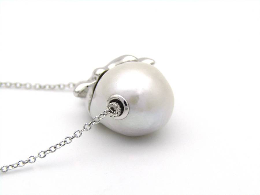 14K gold floating baroque pearl and diamond elephant necklace.