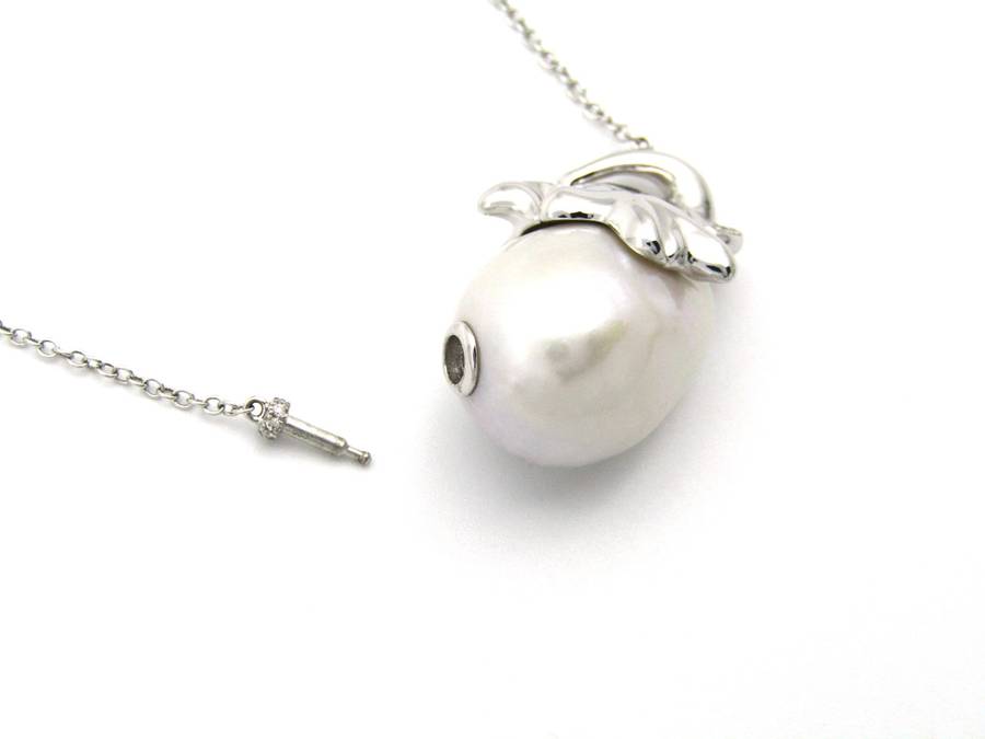 14K gold floating baroque pearl and diamond elephant necklace.