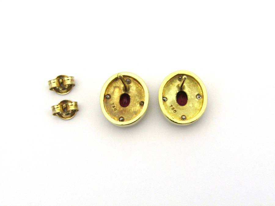 A pair of 18K gold ruby and diamond earrings.