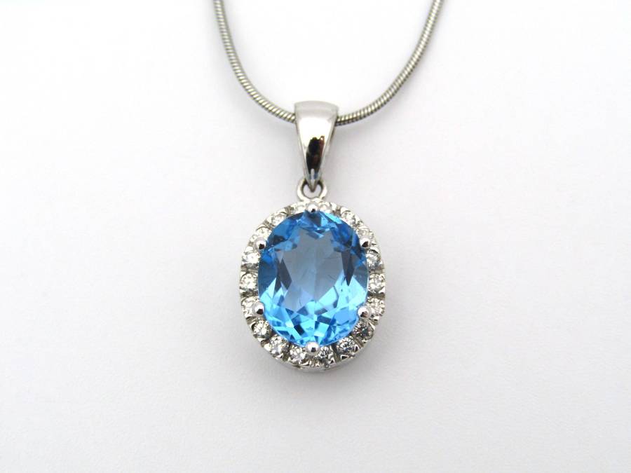 9K gold blue topaz and diamond pendant.