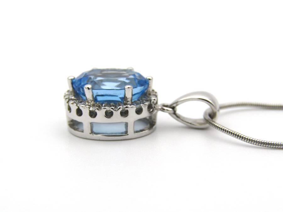 9K gold blue topaz and diamond pendant.