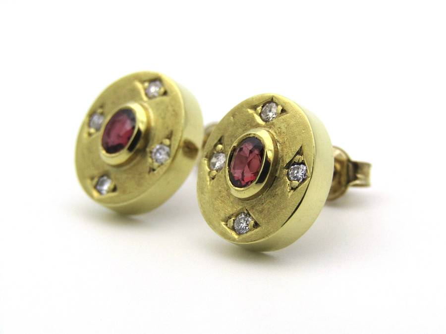 A pair of 18K gold ruby and diamond earrings.