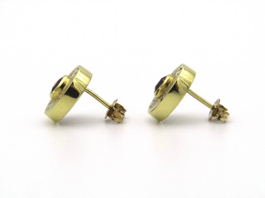 A pair of 18K gold ruby and diamond earrings.