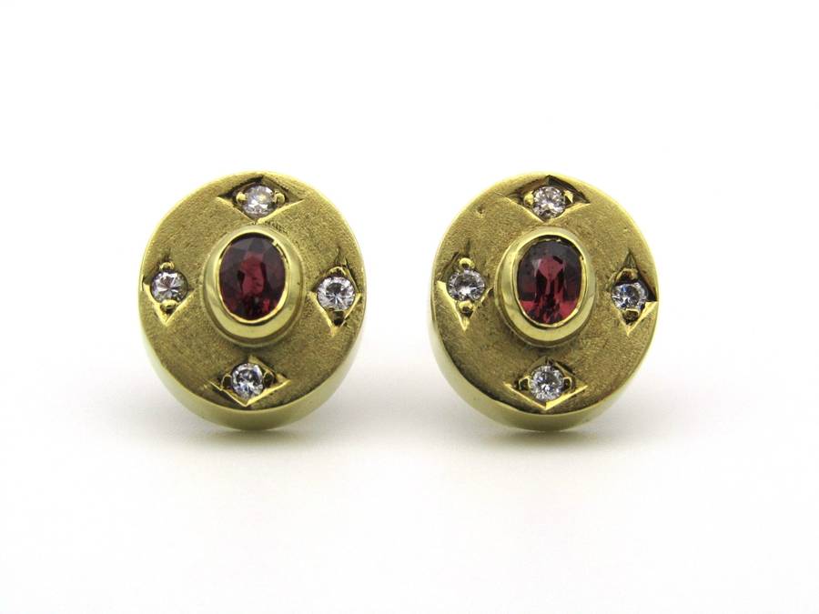 A pair of 18K gold ruby and diamond earrings.