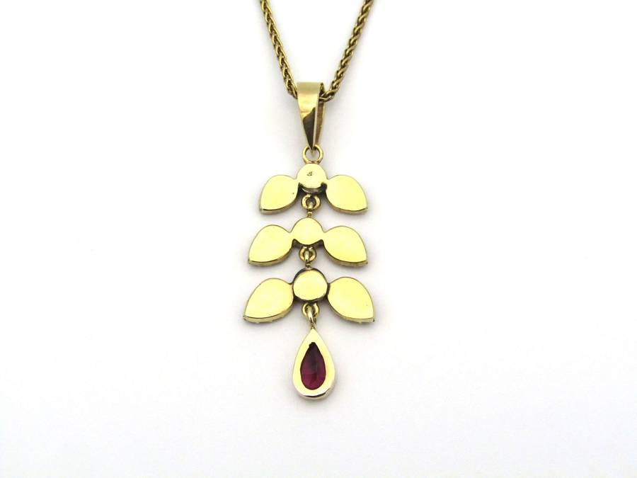 A Vintage 9K gold Almandine garnet and diamond pendant.