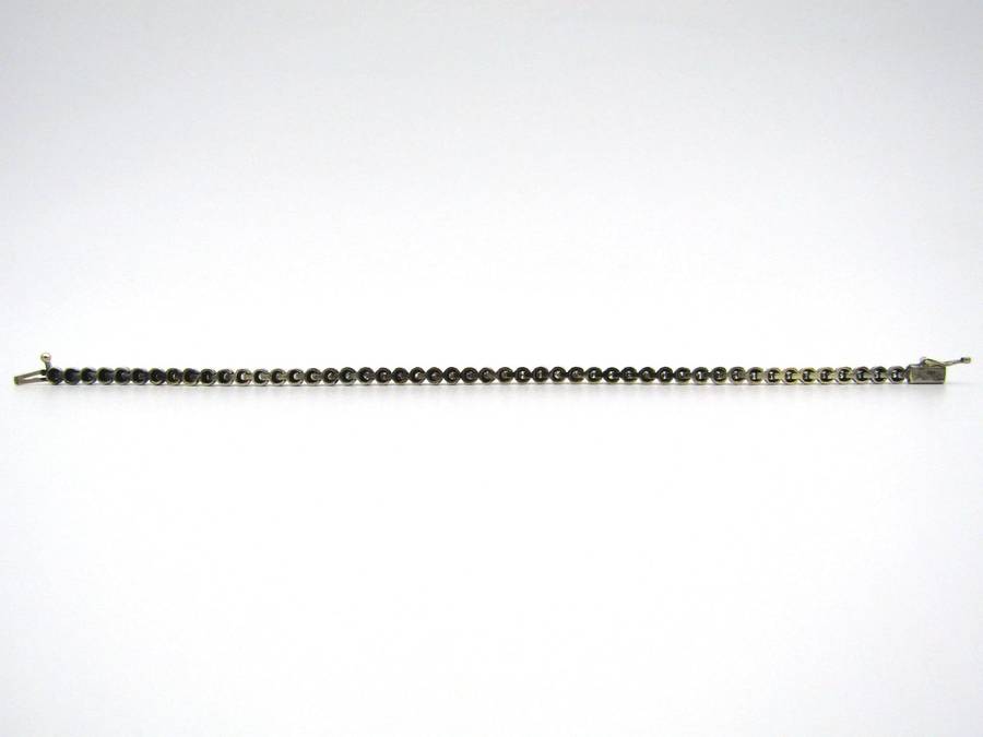 14K gold diamond tennis bracelet.
