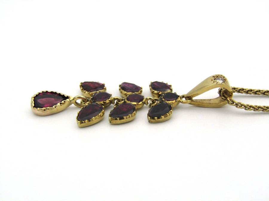 A Vintage 9K gold Almandine garnet and diamond pendant.