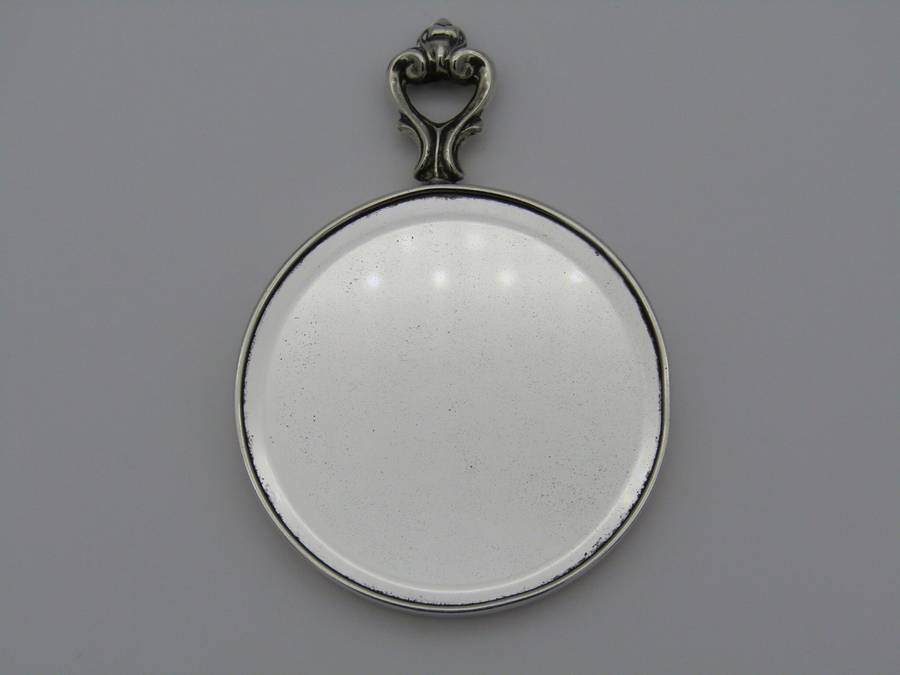 A sterling silver hand mirror by Cartier. Circa 1920s.