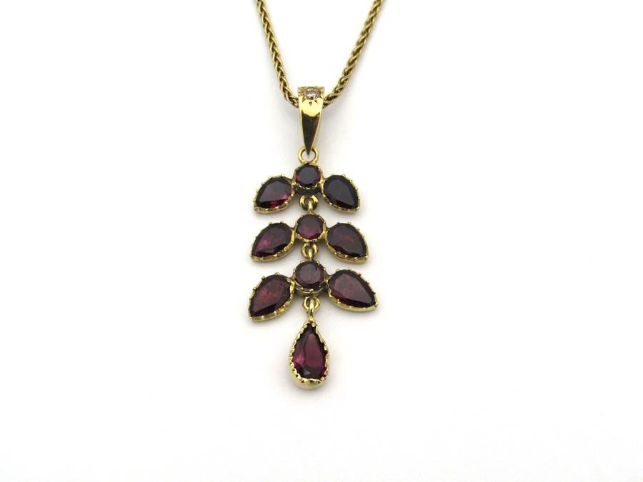 A Vintage 9K gold Almandine garnet and diamond pendant.