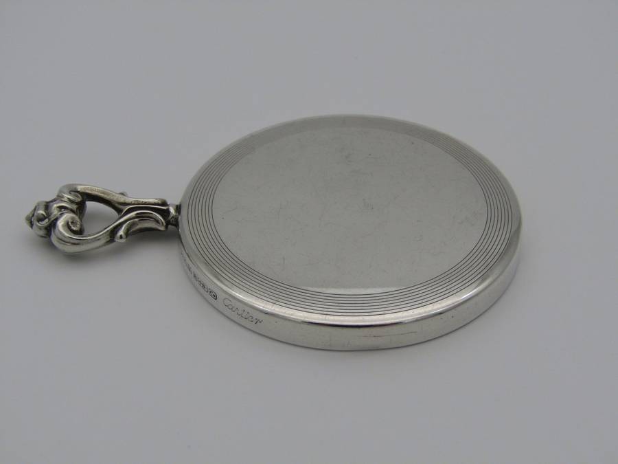 A sterling silver hand mirror by Cartier. Circa 1920s.