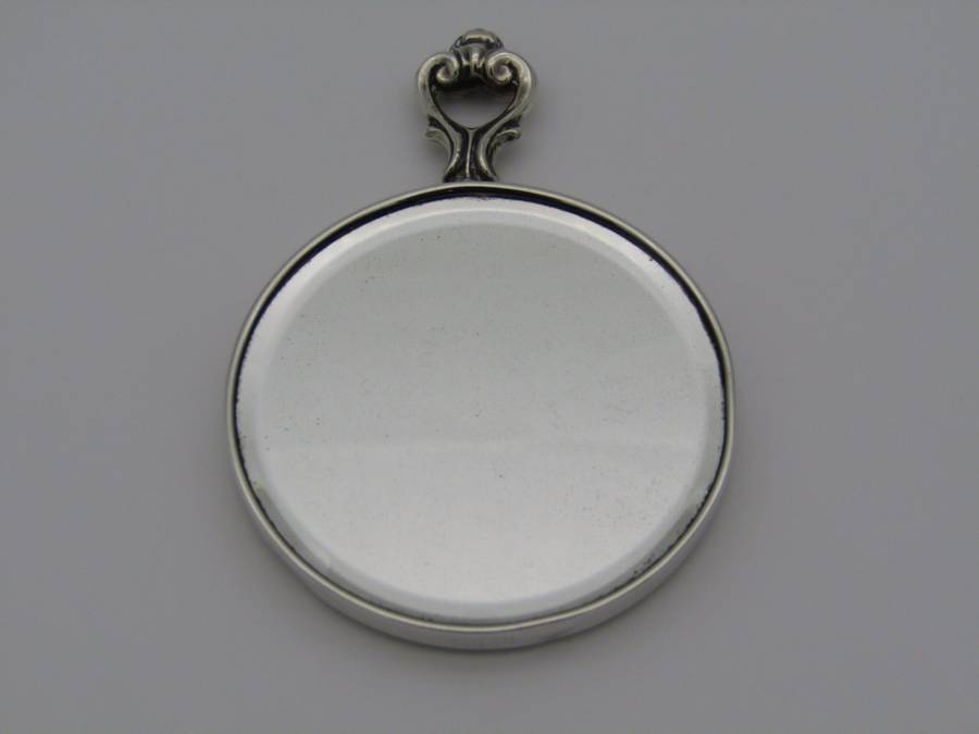 A sterling silver hand mirror by Cartier. Circa 1920s.