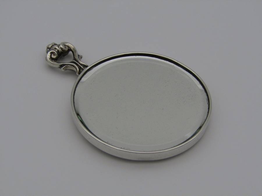 A sterling silver hand mirror by Cartier. Circa 1920s.