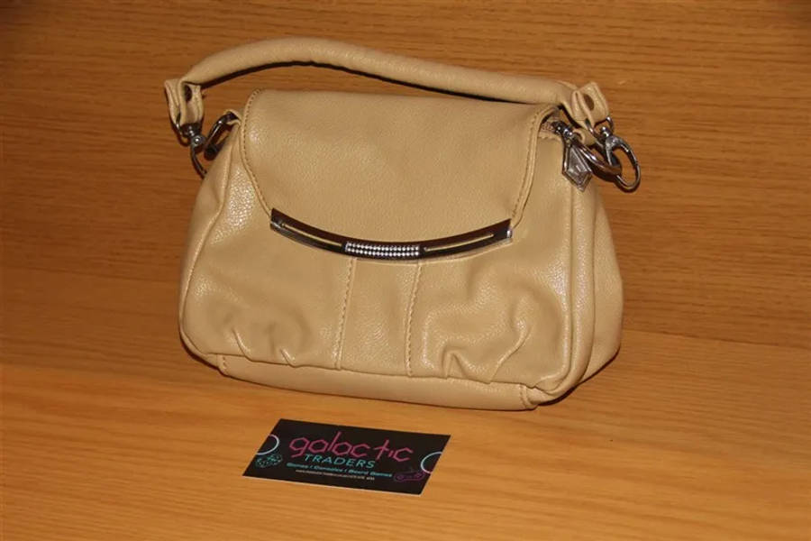 Beige faux leather mini handbag with a top handle and a detachable strap
