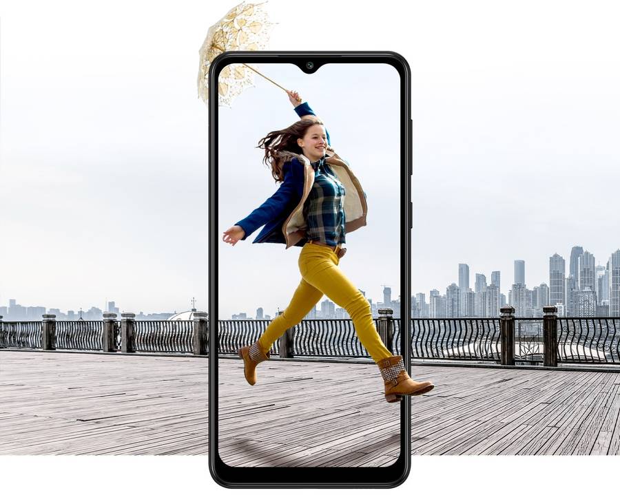A girl is jumping merrily holding an umbrella high in her hand behind the frame of Galaxy A02.