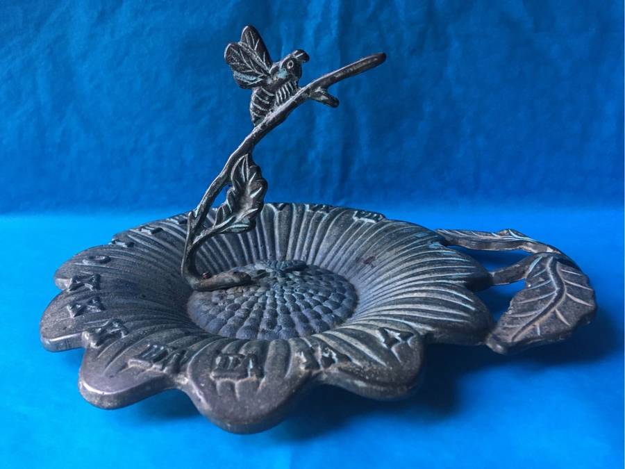 Vintage bronze sundial with dragonfly