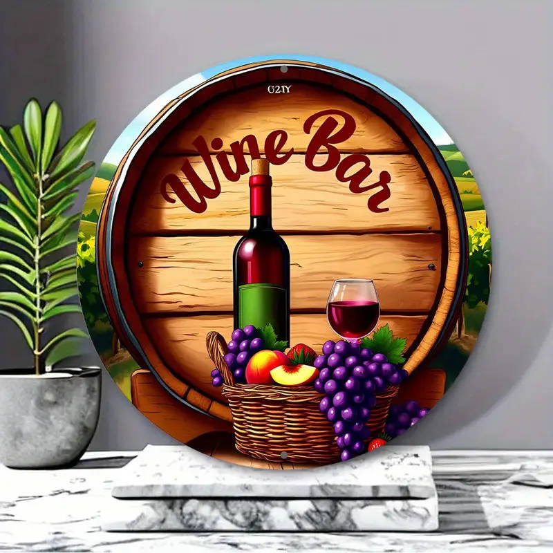 A Bottle Of Wine And a Basket Of Fruit In Front Of a Wreath Sign