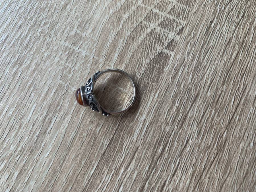 925 Silver Ring With Orange Stone On Raised Setting Surrounded By Swirls #ML700R195.00 | Dimensi...