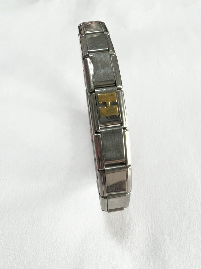 Bracelet - Stainless Steel Nomination Bracelet. One Gold Coloured H Link. (20 Links in total) ML1798