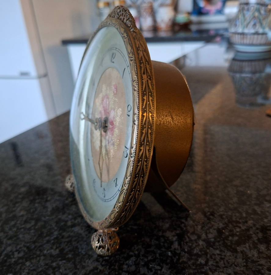 Mechanical Table Clock with petit point face - made in england.  Filigree metal feet.  Working