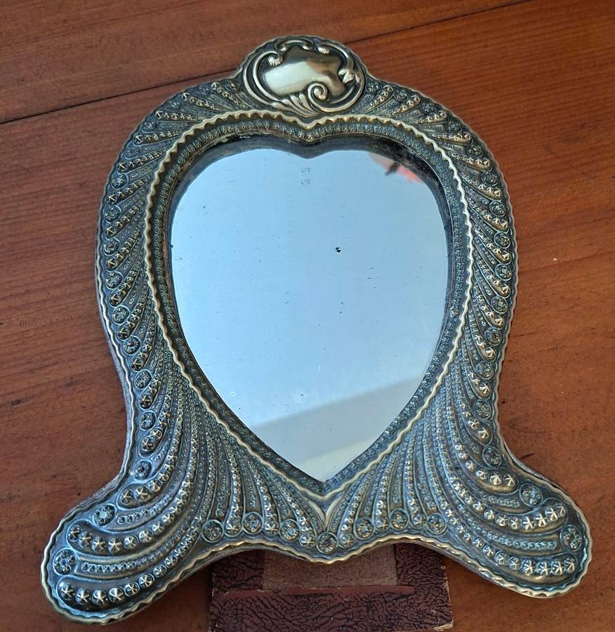 Ornate antique silver plate on brass heart shaped vanity dressing table mirror   14 x 19 cms