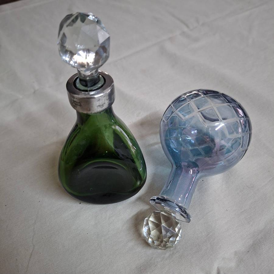 2 perfume bottles approx 16 cms tall - stamped gero. Cut crystal stoppers