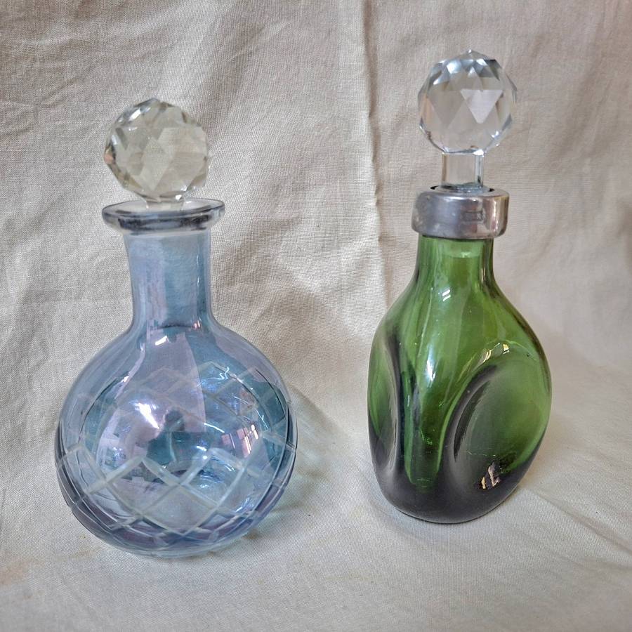 2 perfume bottles approx 16 cms tall - stamped gero. Cut crystal stoppers