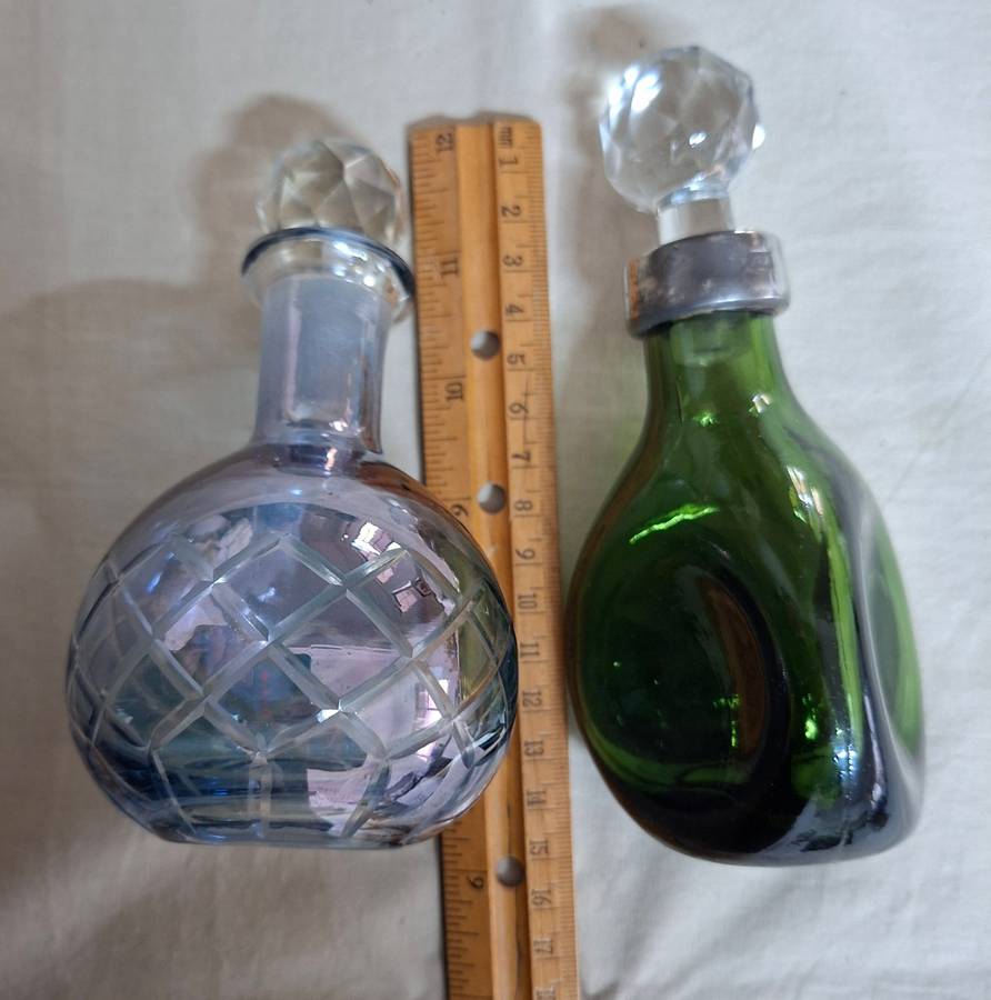 2 perfume bottles approx 16 cms tall - stamped gero. Cut crystal stoppers