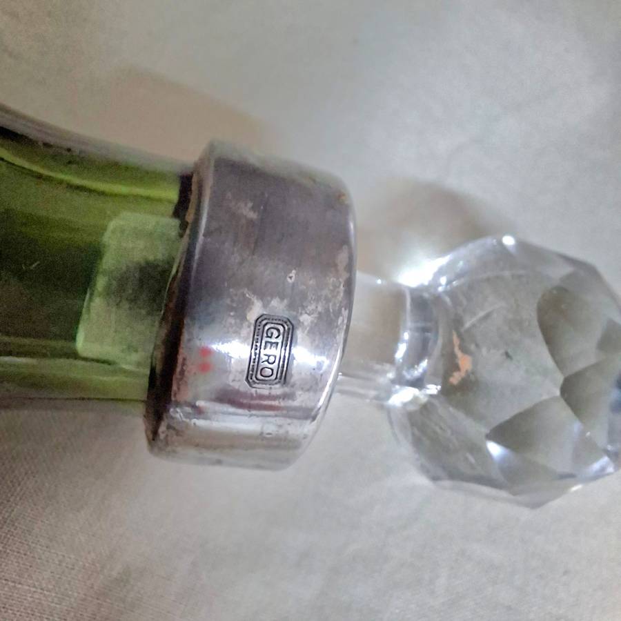 2 perfume bottles approx 16 cms tall - stamped gero. Cut crystal stoppers