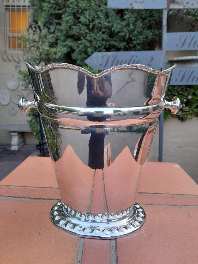 A Silver-Plate Ice Bucket  The Wavy Rim Above A Tapering Body, Applied Opposing Handles, Raised ...