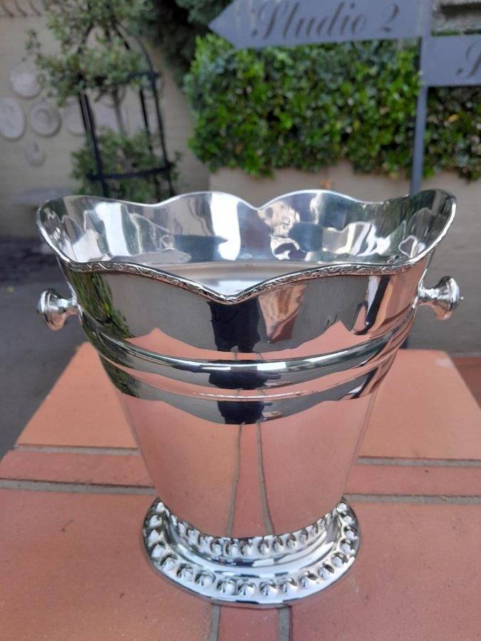 A Silver-Plate Ice Bucket  The Wavy Rim Above A Tapering Body, Applied Opposing Handles, Raised ...