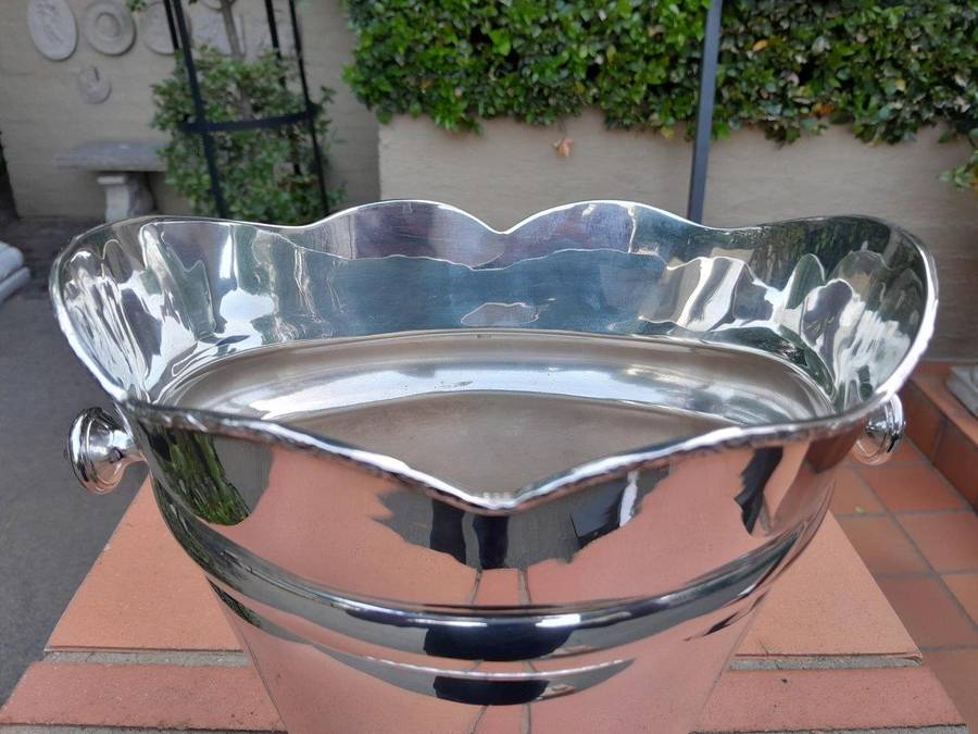 A Silver-Plate Ice Bucket  The Wavy Rim Above A Tapering Body, Applied Opposing Handles, Raised ...