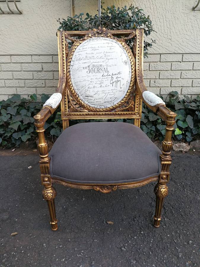 An Exceptional Pair of French Style Carved and Gilded Armchairs Upholstered in a Custom-Made Line...