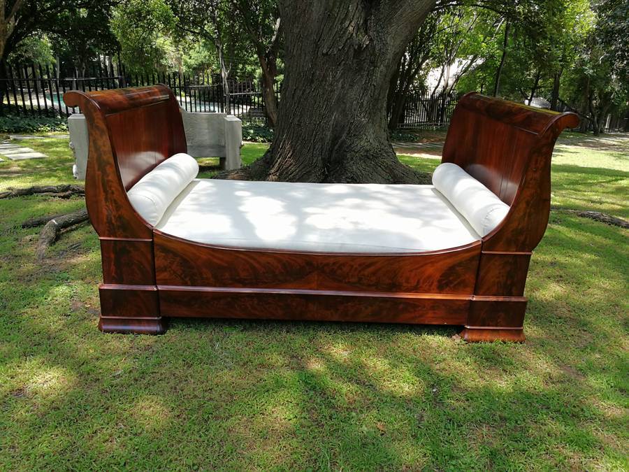 A French Flame Mahogany Lit-En-Bateau / Daybed on Wooden Castors. Circa 1950