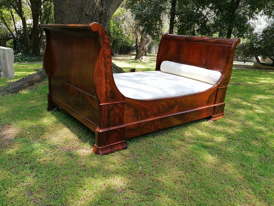 A French Flame Mahogany Lit-En-Bateau / Daybed on Wooden Castors. Circa 1950