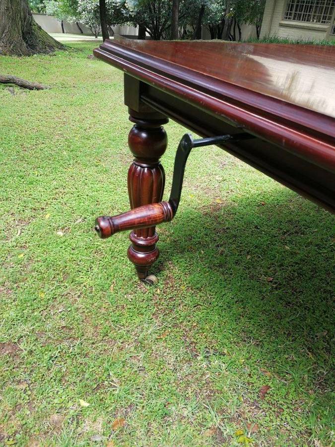 A Victorian Style Mahogany extending ten-seater dining room table on brass castors and with windi...