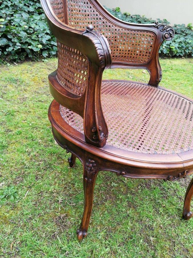 A French Walnut Carved And Rattan Chair
