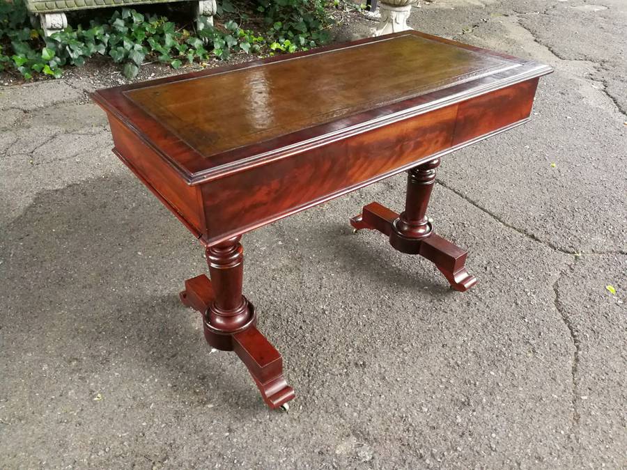 A 19th Century Flamed Mahogany Sofa / Writing Table with Leather and Hand Tooled Top On Cators