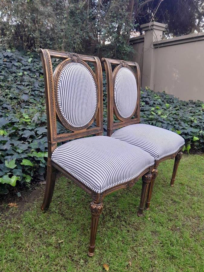 A Pair of French Style Hand-Gilded Chairs
