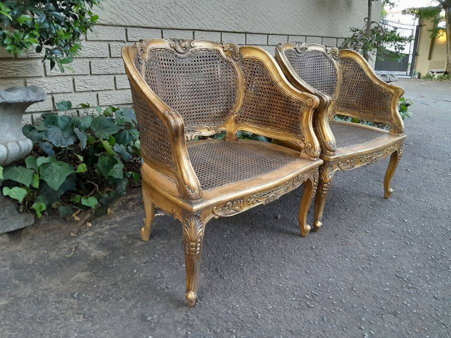 A 20th Century Pair or French Bergere Style Carved and Hand Gilded in Gold Leaf Wooden Chairs