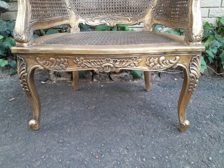 A 20th Century Pair or French Bergere Style Carved and Hand Gilded in Gold Leaf Wooden Chairs