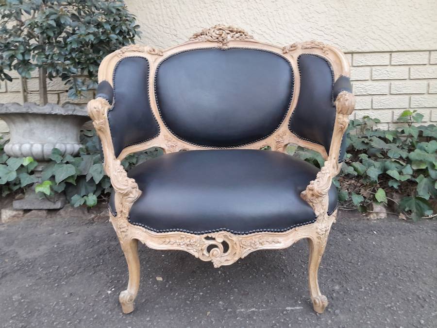 A 20TH Century French Style Bergere Style Carved Chair in a Contemporary Natural Wood Finish upho...
