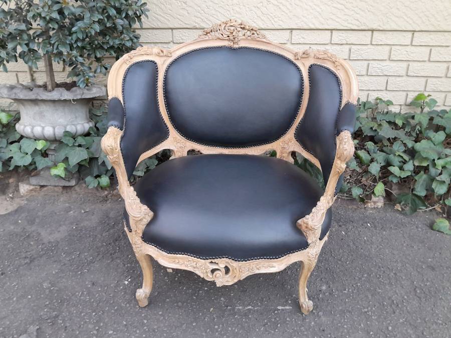 A 20TH Century French Style Bergere Style Carved Chair in a Contemporary Natural Wood Finish upho...