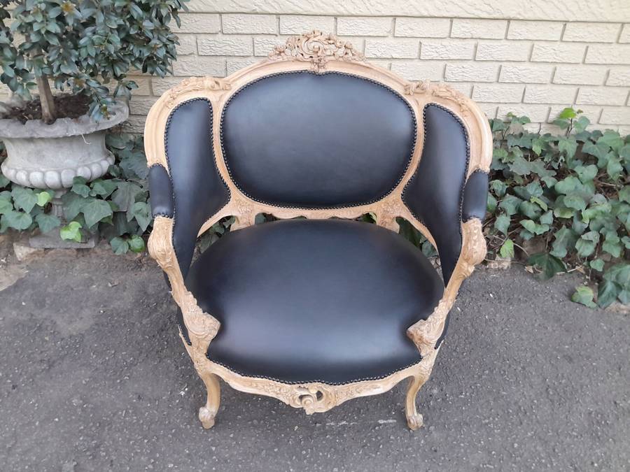 A 20TH Century French Style Bergere Style Carved Chair in a Contemporary Natural Wood Finish upho...