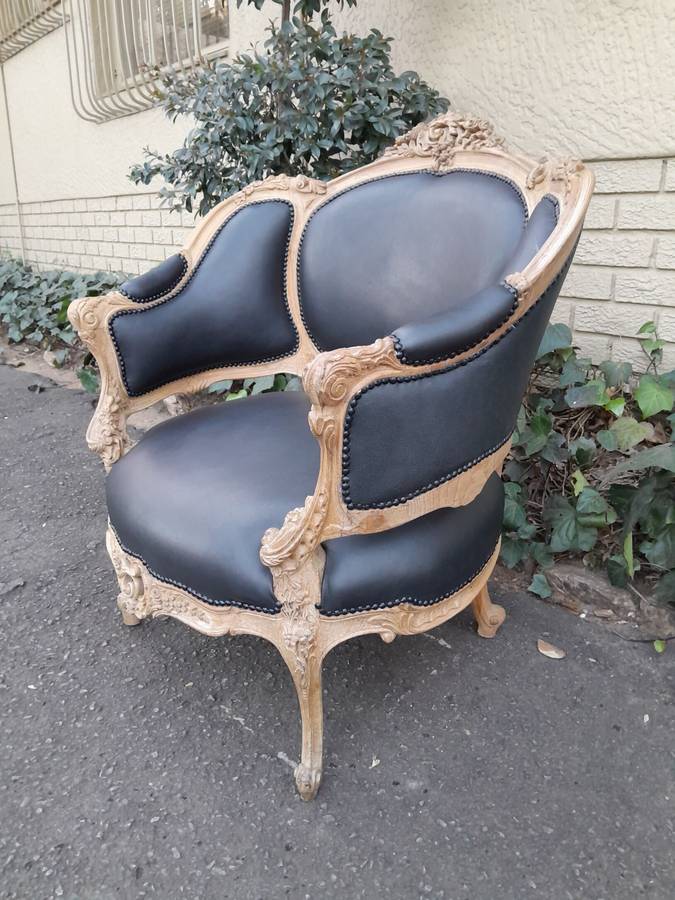 A 20TH Century French Style Bergere Style Carved Chair in a Contemporary Natural Wood Finish upho...