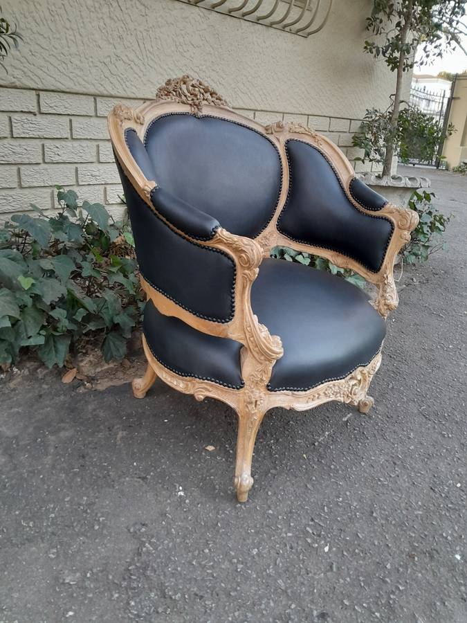 A 20TH Century French Style Bergere Style Carved Chair in a Contemporary Natural Wood Finish upho...
